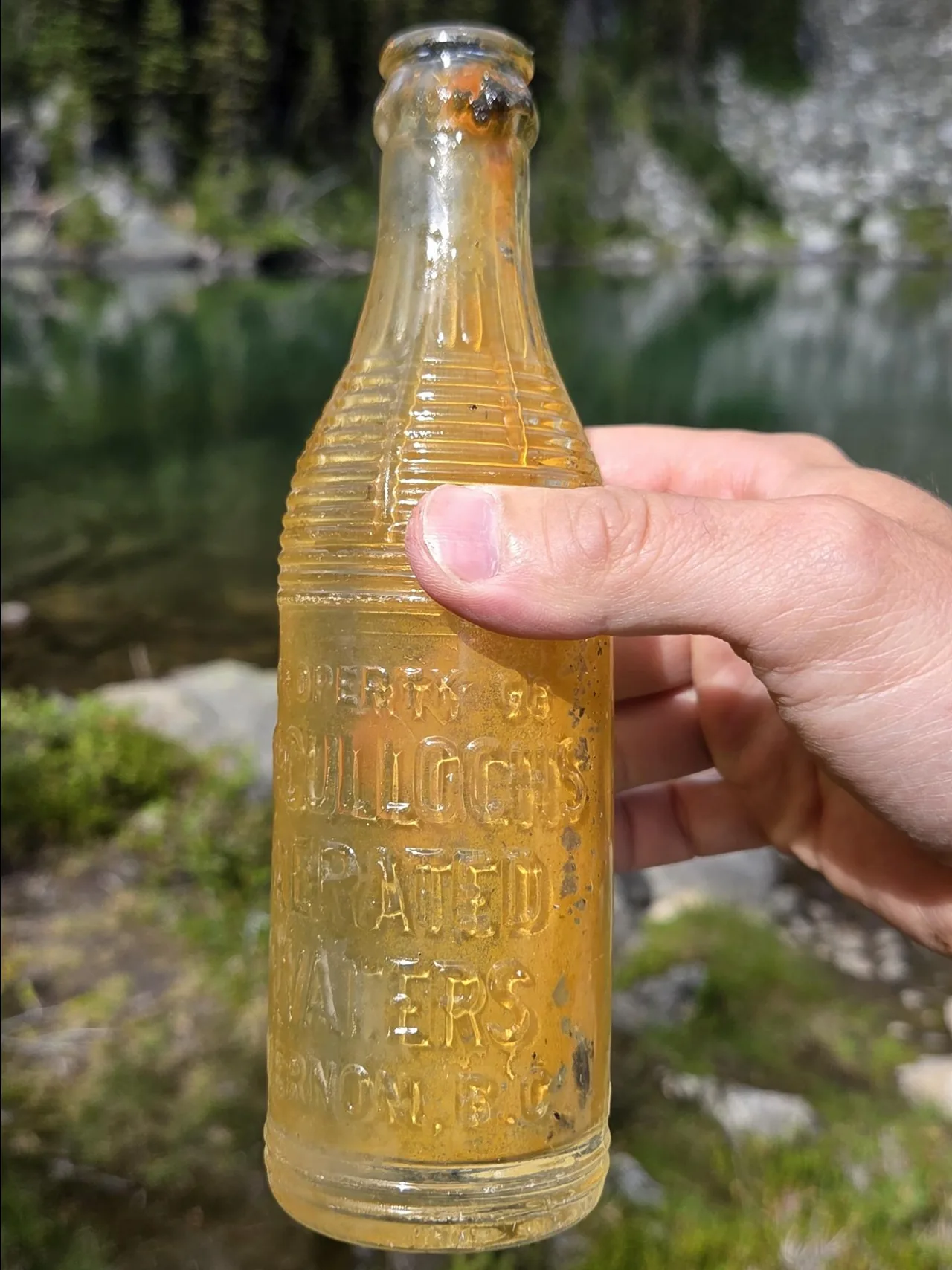 Found it in Miller Lake, B.C., Canada. Wanted to clean it from trash.
Google Lens says its 100 years old and from "McCulloch's Aerated Waters, Vernon, B.C.".